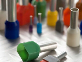 Colorful dental burrs on a white surface